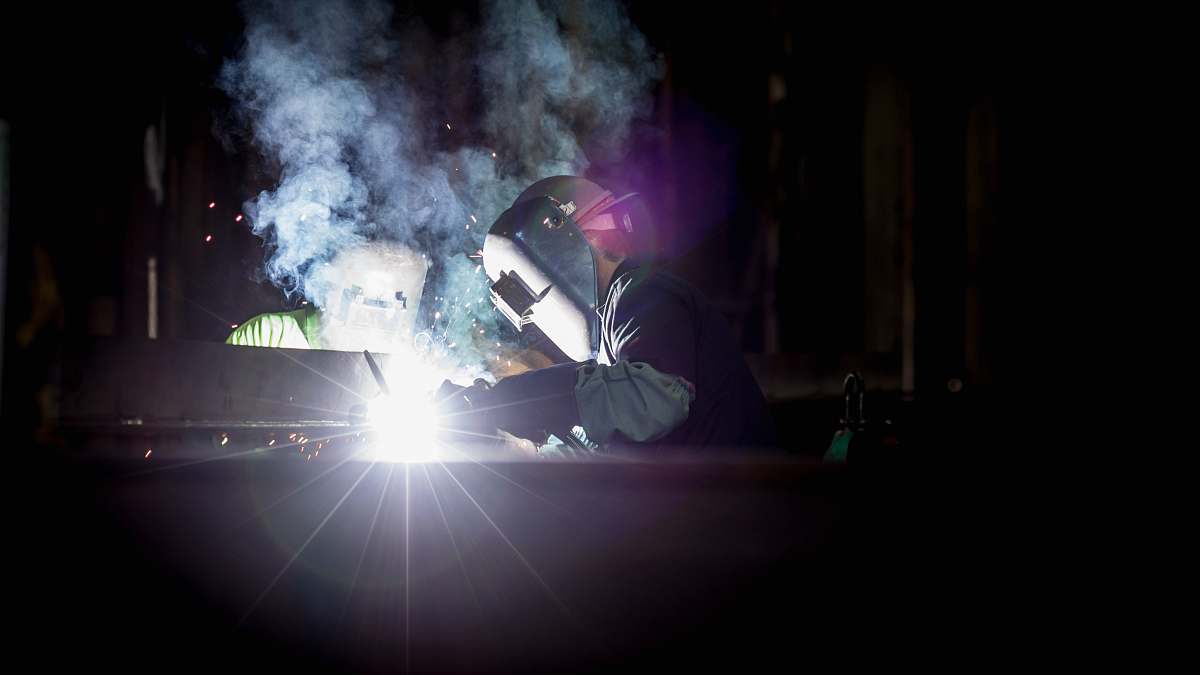 vigor marine person welding metal using gray helmet portland